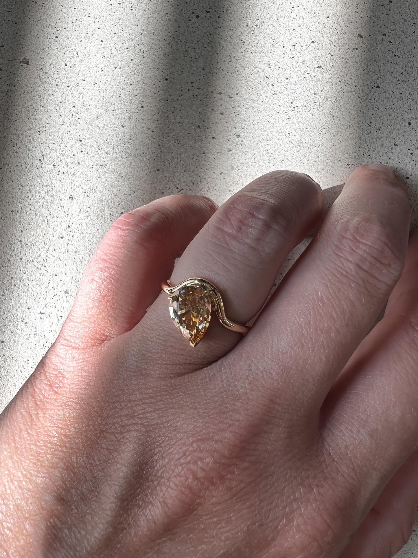 Tilted Floating Old Mine Antique Champagne Pear Cut Moissanite Engagement Ring.
