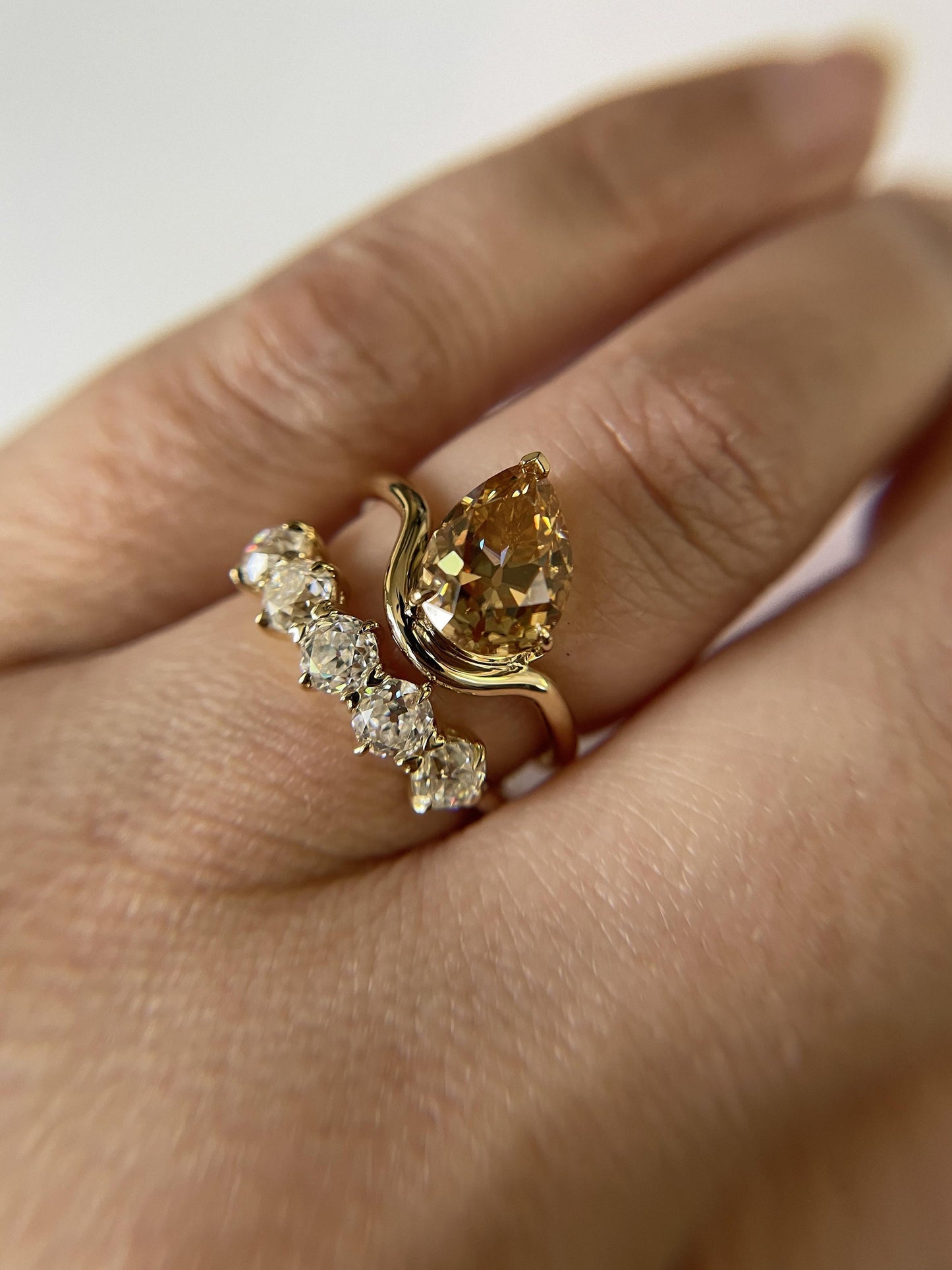Tilted Floating Old Mine Antique Champagne Pear Cut Moissanite Engagement Ring.