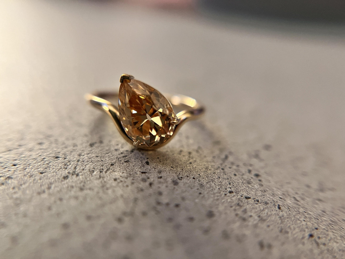 Tilted Floating Old Mine Antique Champagne Pear Cut Moissanite Engagement Ring.