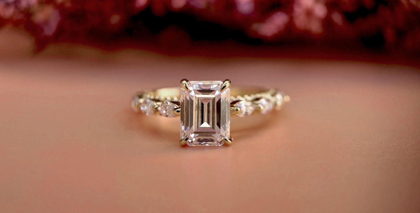 Emerald Cut Moissanite Solitaire Engagement Ring with Side east-west set Marquise, Unique Cathedral setting and millegrain detail.