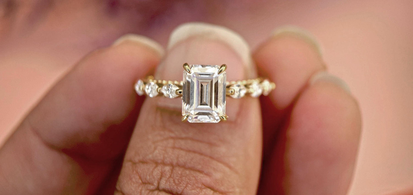Emerald Cut Moissanite Solitaire Engagement Ring with Side east-west set Marquise, Unique Cathedral setting and millegrain detail.